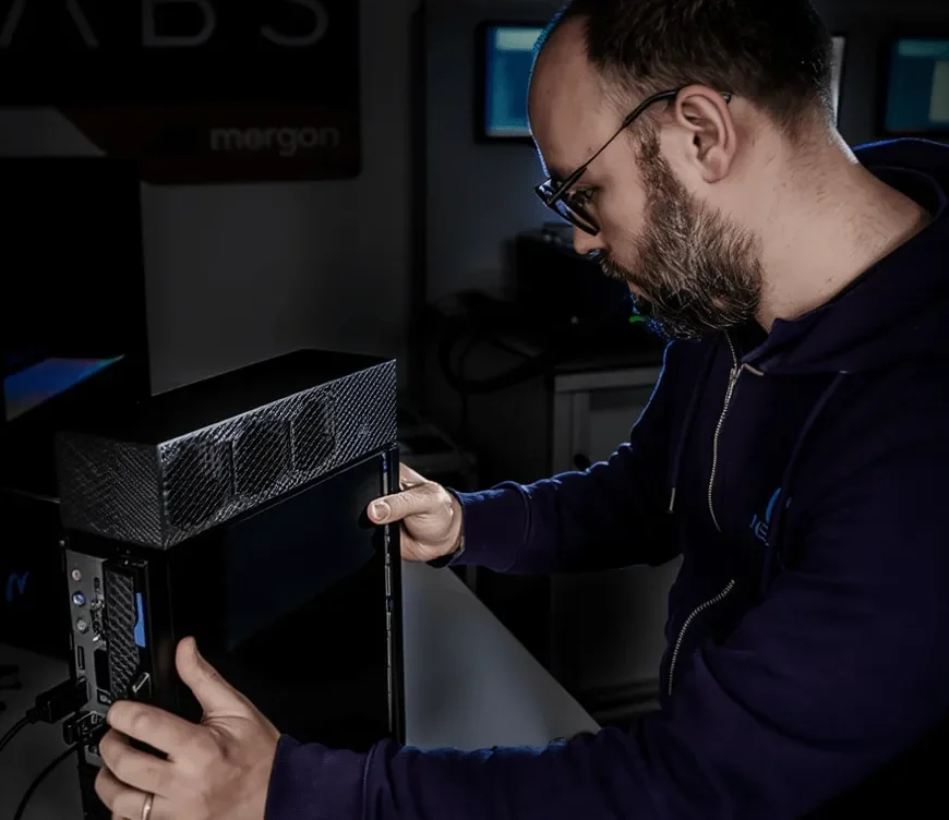 A nexalus team member working on the side panel of a computer