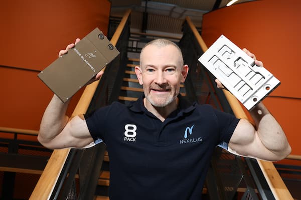 Nexalus/8PACK team member holding cooling solutions in hand