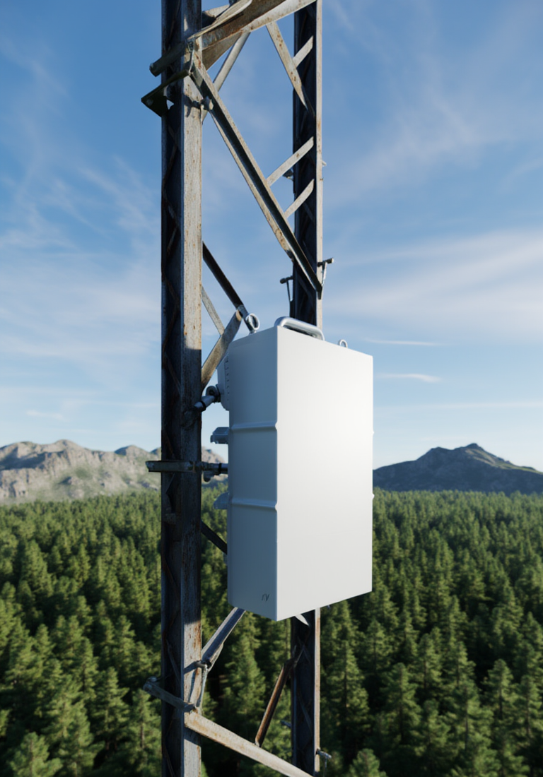 Off white box on a pole in a forest area with mountains in the distance